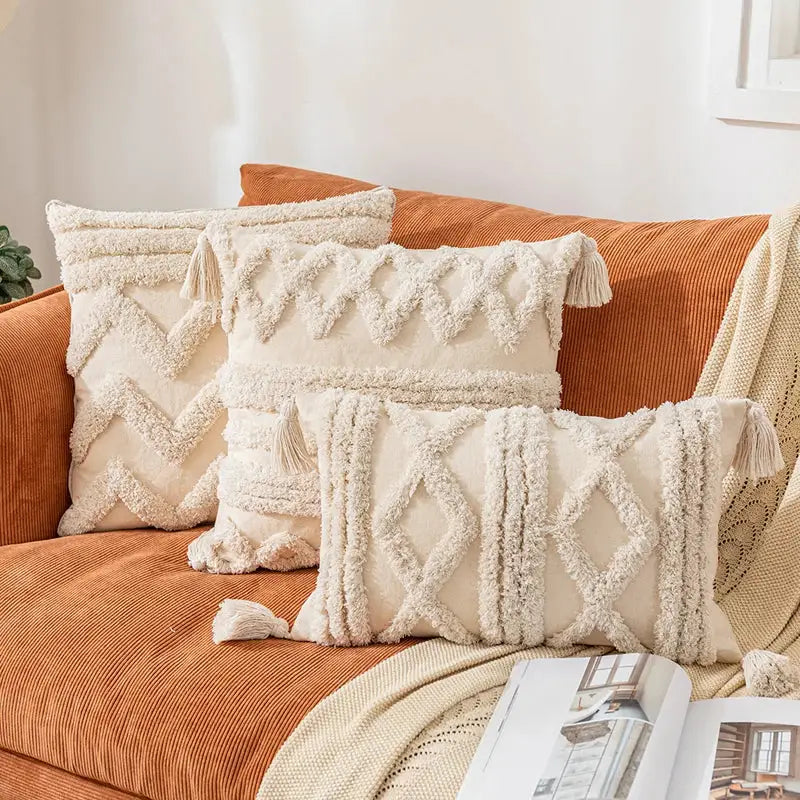 Cream-colored textured cushion covers with woven geometric patterns and tassels for decorbites bohemian tassel living room decor