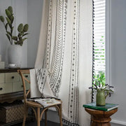 Cream-colored curtains with black ethnic geometry printed patterns and tassel trim for bohemian ethnic decorbites living room