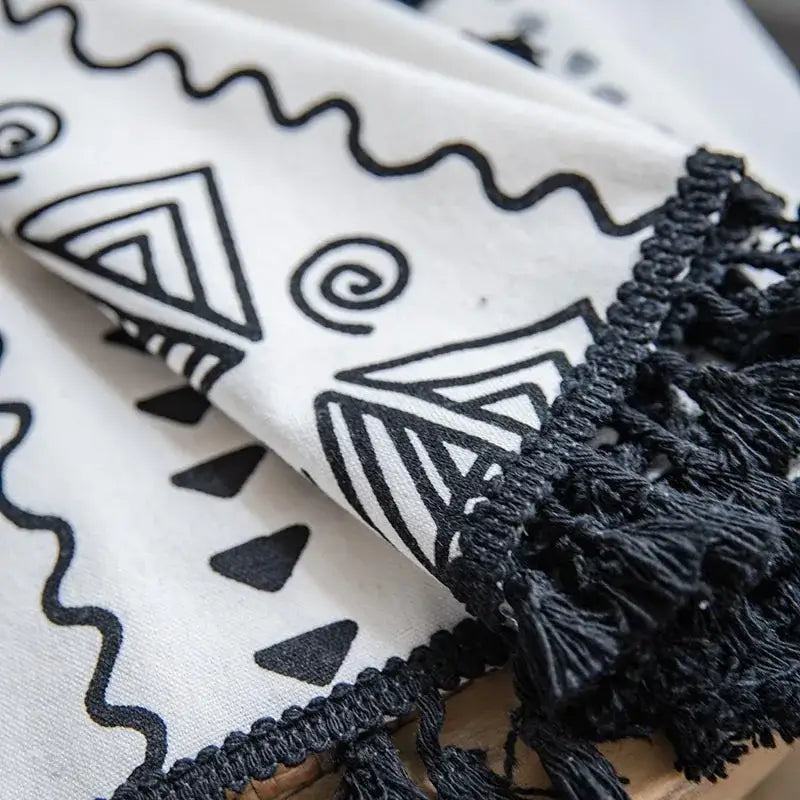 White fabric scarf with black ethnic geometry printed patterns and fringed edge complementing decorbites bohemian ethnic style