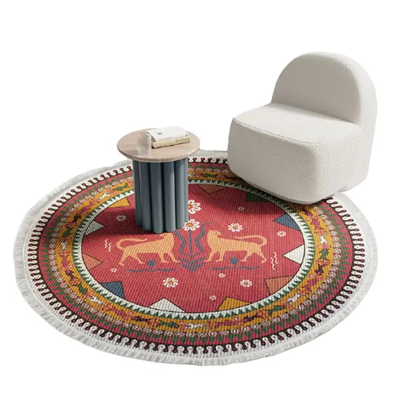 Vibrant red and gold decorbites bohemian ethnic round area rug with geometric and animal motifs and white fringe border