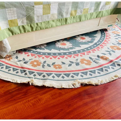 Cream-colored woven bohemian ethnic round area rug with floral geometric patterns in orange teal and red decorbites bohemian ethnic