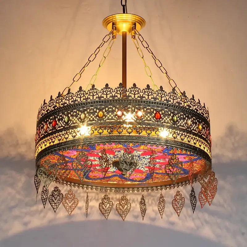 Ornate brass pendant lights with intricate filigree and colorful mosaic glass panels by decorbites bohemian exotic for dining rooms