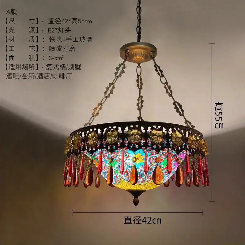 A vibrant handcrafted bohemian exotic stained glass pendant light with gold red beads and black wrought iron frame for dining room