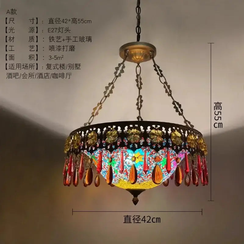 A vibrant bohemian exotic stained glass pendant light with a black wrought iron frame and gold red beads for dining decor