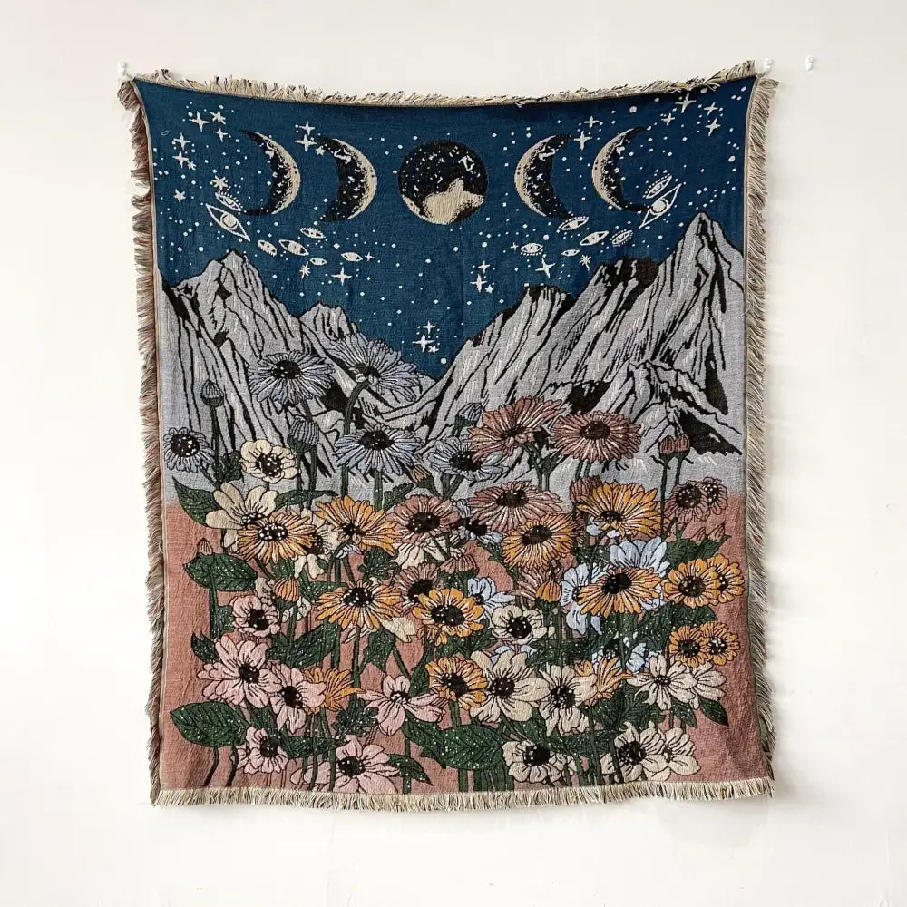Bohemian throw blanket featuring celestial moon phases above mountains and floral field with fringed edges decorbites throw blanket