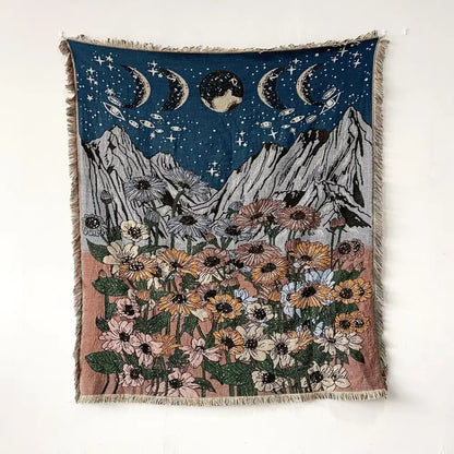 Bohemian throw blanket featuring celestial moon phases above mountains and floral field with fringed edges decorbites throw blanket