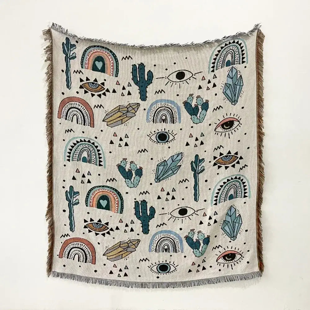 Beige woven bohemian throw blanket with whimsical cacti and celestial patterns in teal coral and black decorbites throw blanket