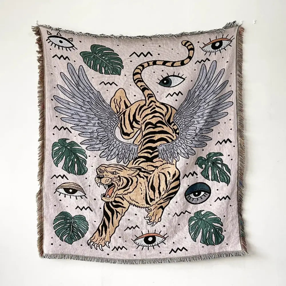 Beige woven bohemian throw blanket featuring a winged tiger and green monstera leaves for stylish living room decor