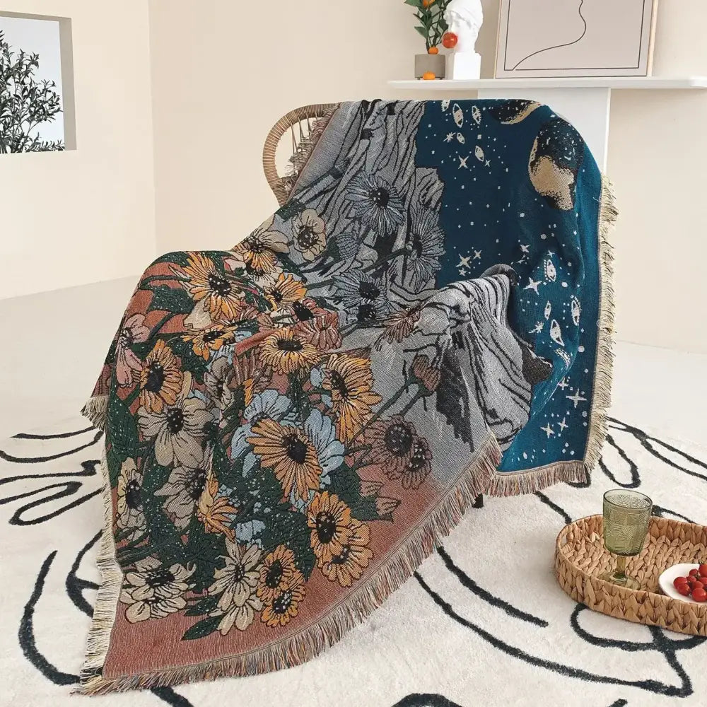 A cozy decorbites bohemian throw blanket with vibrant floral and celestial woven design and fringed edges for living room decor