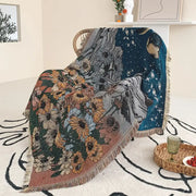 A cozy decorbites bohemian throw blanket with vibrant floral and celestial woven design and fringed edges for living room decor