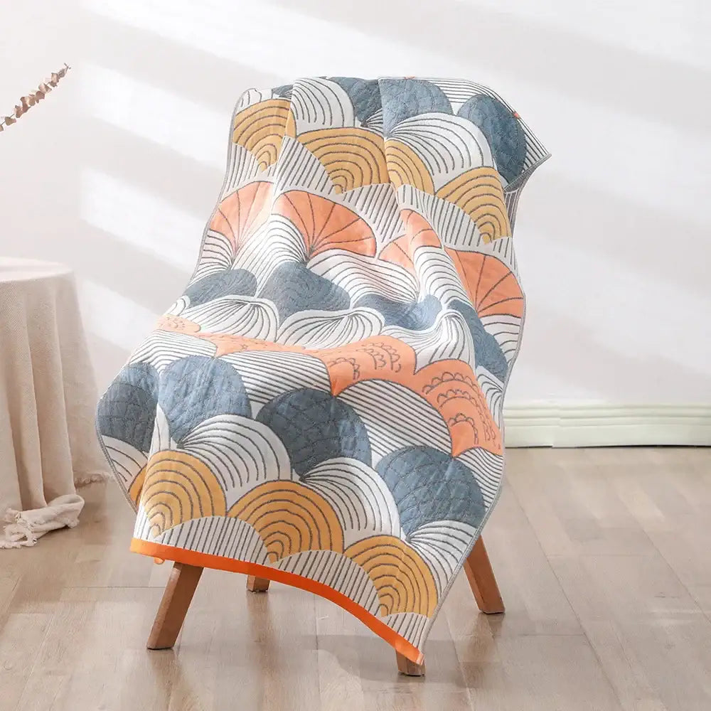 A cozy quilted chair cover with a vibrant orange blue-gray and white pattern featuring decorbites bohemian floral cotton bath towel design