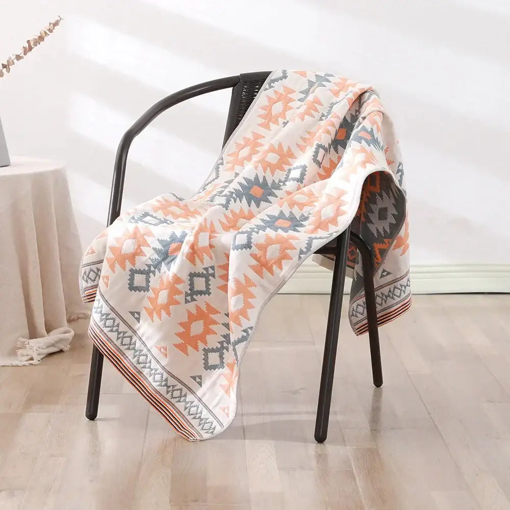A cozy cream bath towel with vibrant orange and gray geometric patterns from decorbites bohemian floral cotton
