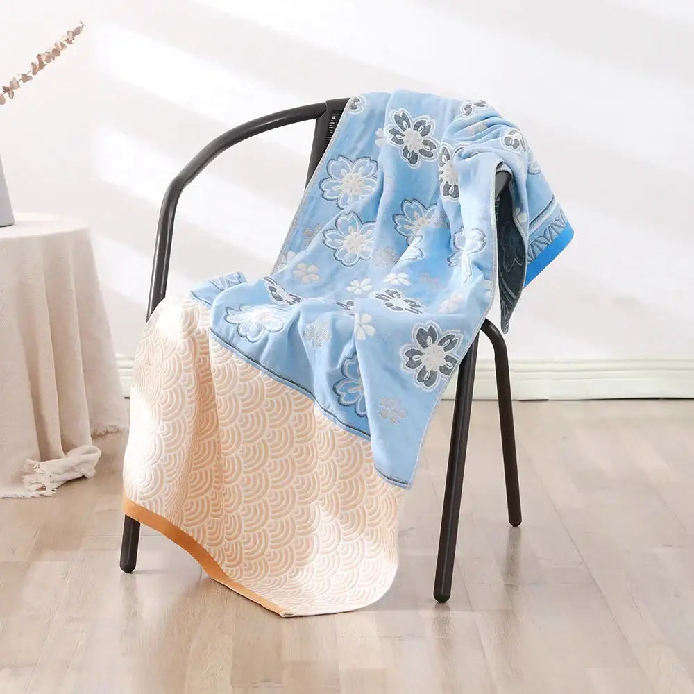 Bohemian floral cotton bath towel with light blue embroidered floral top and cream wave texture bottom by decorbites