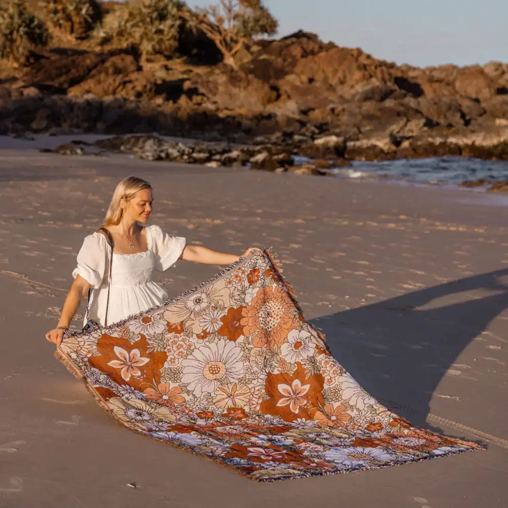 A soft woven bohemian floral leisure blanket in rust and cream with vibrant floral pattern for living room decorbites