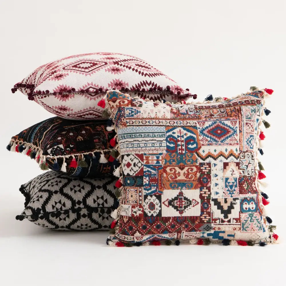 Vibrant patchwork cushion cover with intricate geometric and tribal patterns and colorful tassels for bohemian flower decorbites style