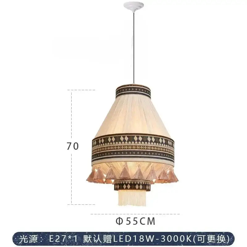 Cream-colored cone-shaped bohemian fringe pendant lamp with black and gold geometric patterns and copper tassels