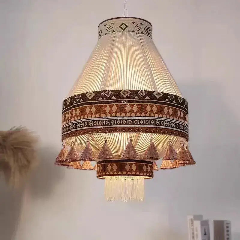Bohemian fringe pendant lamp with warm-toned brown and cream geometric fabric bands and hanging woven tassels for dining room