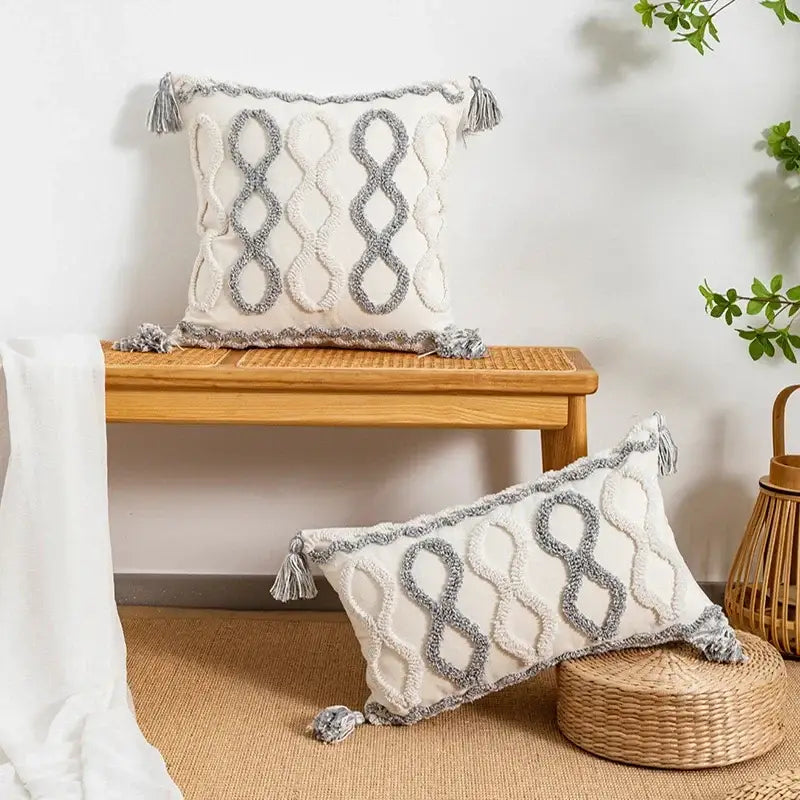 Cream-colored rectangular cushion cover with gray embroidered infinity symbols and tassel trim for living room decorbites geometric tufted pillow cover
