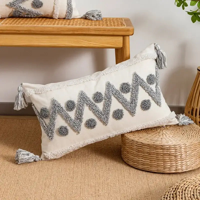 Cream-colored cushion cover with gray geometric zigzag and dot embroidery and tassels by decorbites geometric tufted