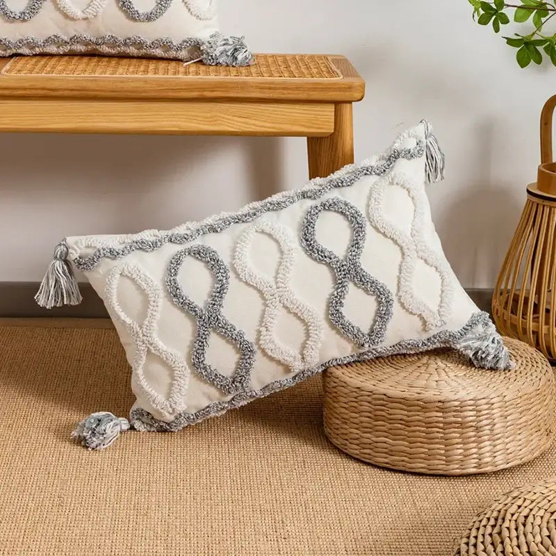 Cream-colored cushion cover with gray and white woven geometric tufted pattern and tassels decorbites pillow cover