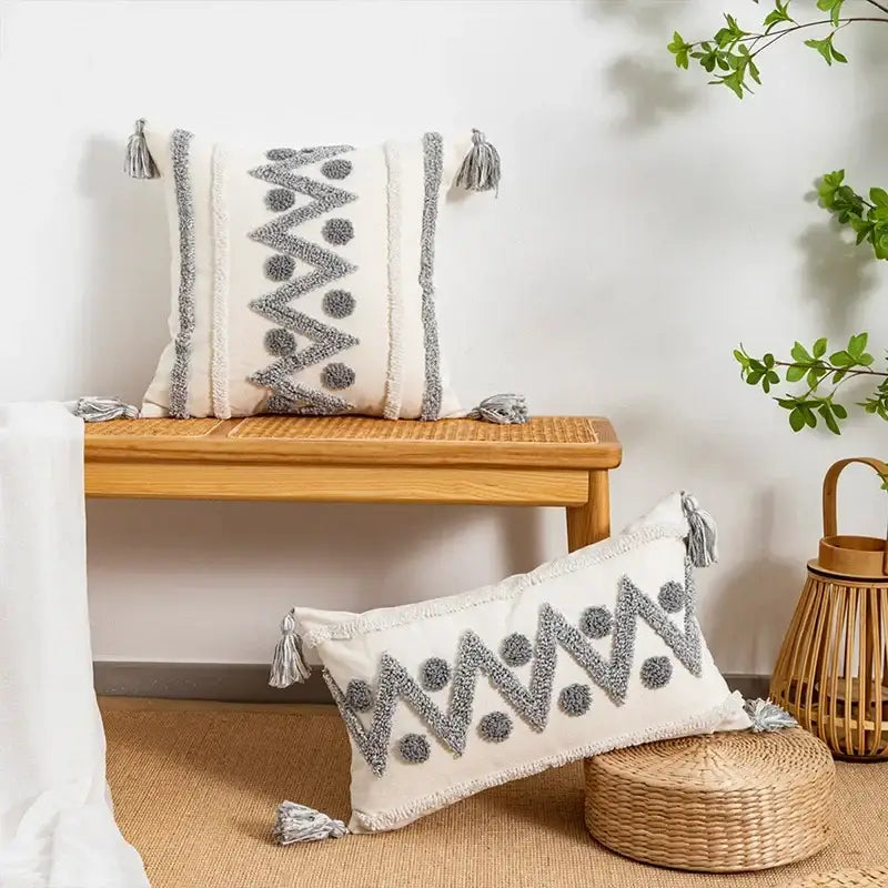Cream-colored cushion cover with gray woven zigzag dot patterns and tassels by decorbites geometric tufted design