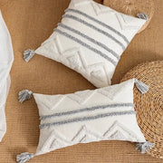 Cream-colored cushion cover with textured gray geometric patterns and tassels for living room decorbites geometric tufted style