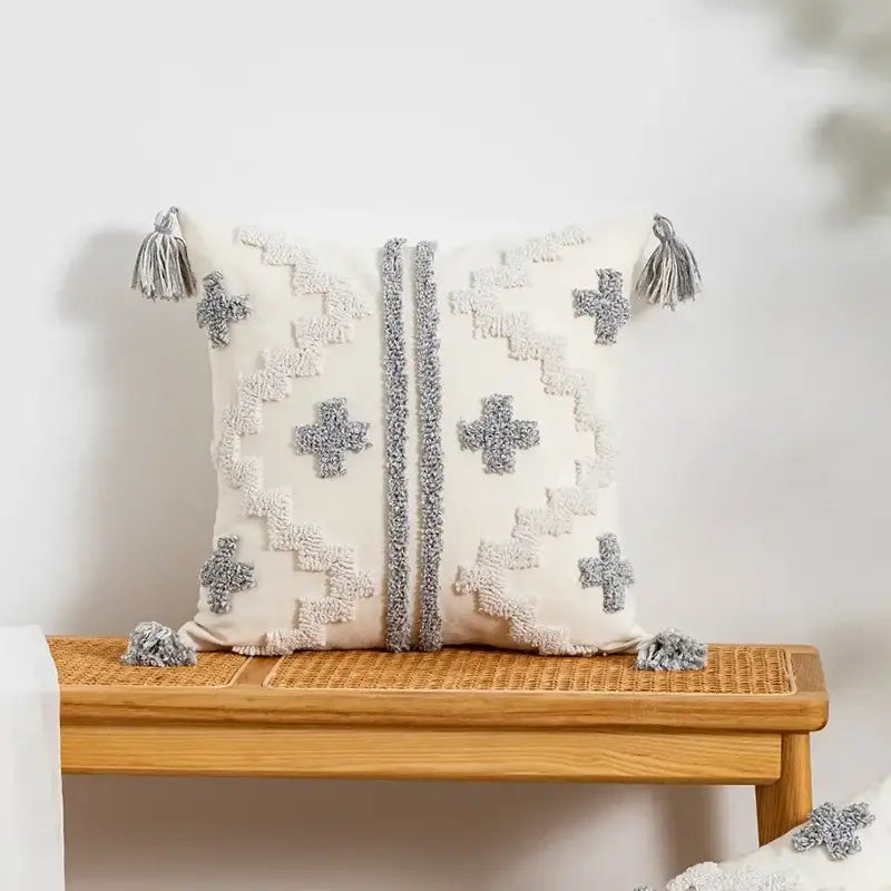 Cream-colored cushion cover with textured gray geometric patterns and tassels by decorbites geometric tufted pillow cover