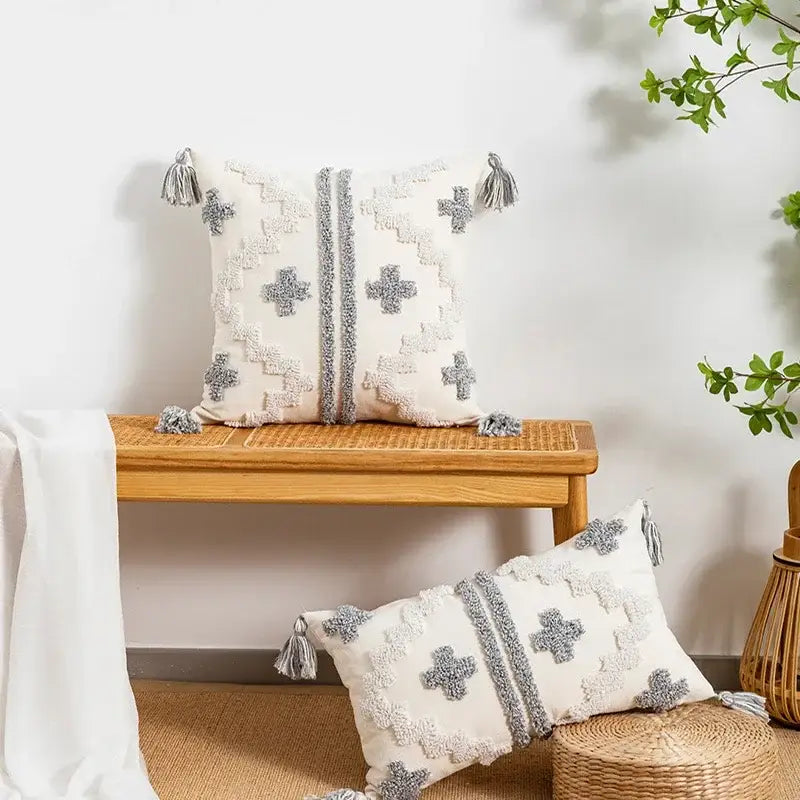 Cream-colored cushion cover with gray cross and zigzag embroidery and tassels by decorbites geometric tufted pillow cover