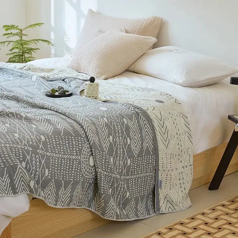 Bohemian gray and white cotton throw blanket with geometric tribal patterns and soft textured weave by decorbites