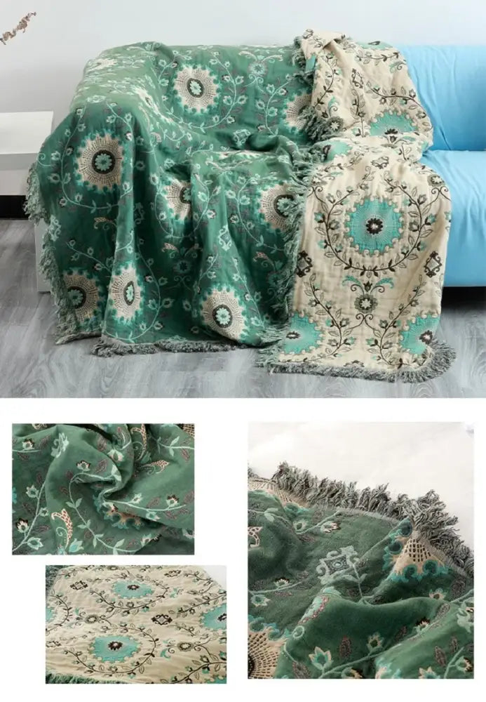 A plush green and cream decorbites bohemian cotton throw blanket with teal floral embroidery and fringed edges for sofa or bed