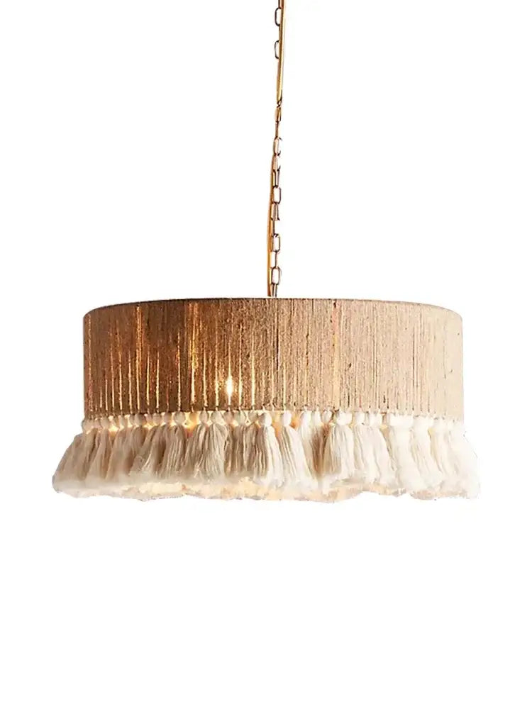 Cylindrical pendant light with textured gold finish and cream tassels from decorbites bohemian hemp rope collection