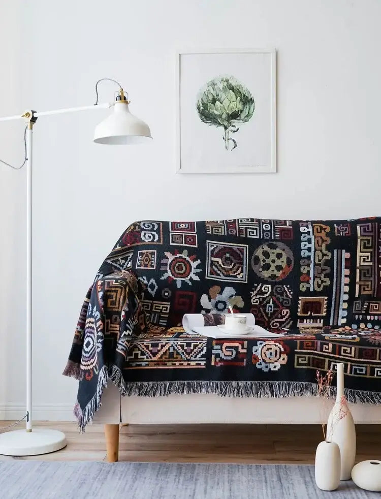 Black bohemian jacquard throw blanket with intricate geometric and floral patterns and fringed edges for living room decor