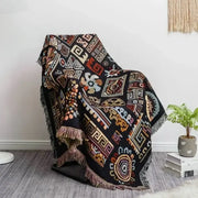 Black and red bohemian jacquard throw blanket with intricate geometric tribal patterns and fringed edges for living room decor