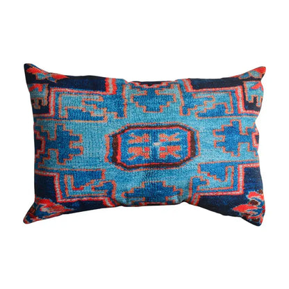 A rectangular bohemian jute linen pillow cover with bold blue and red geometric patterns for living room decor