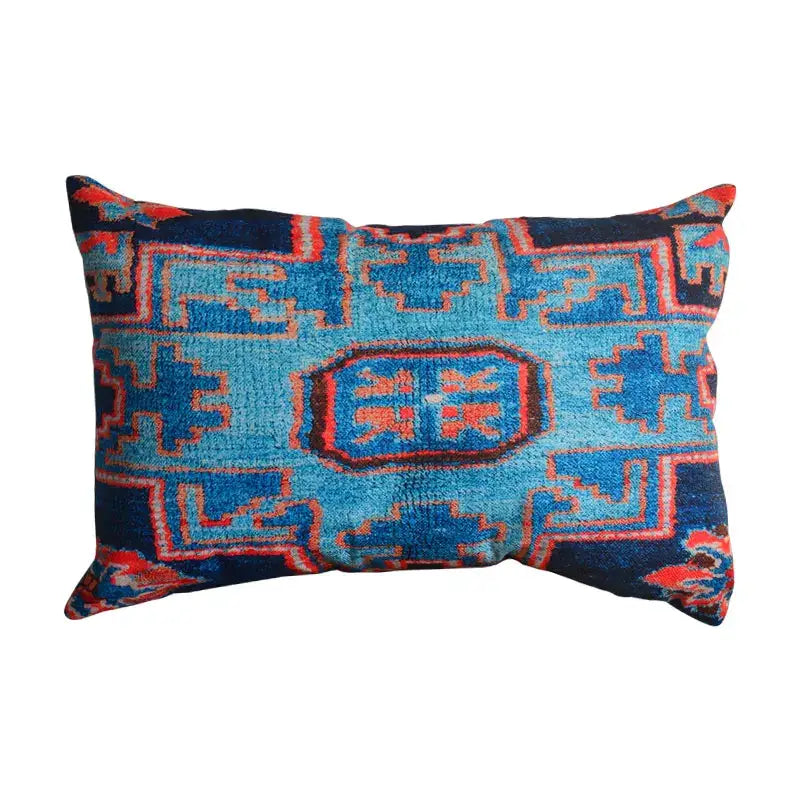 A rectangular bohemian jute linen pillow cover with bold blue and red geometric patterns for living room decor