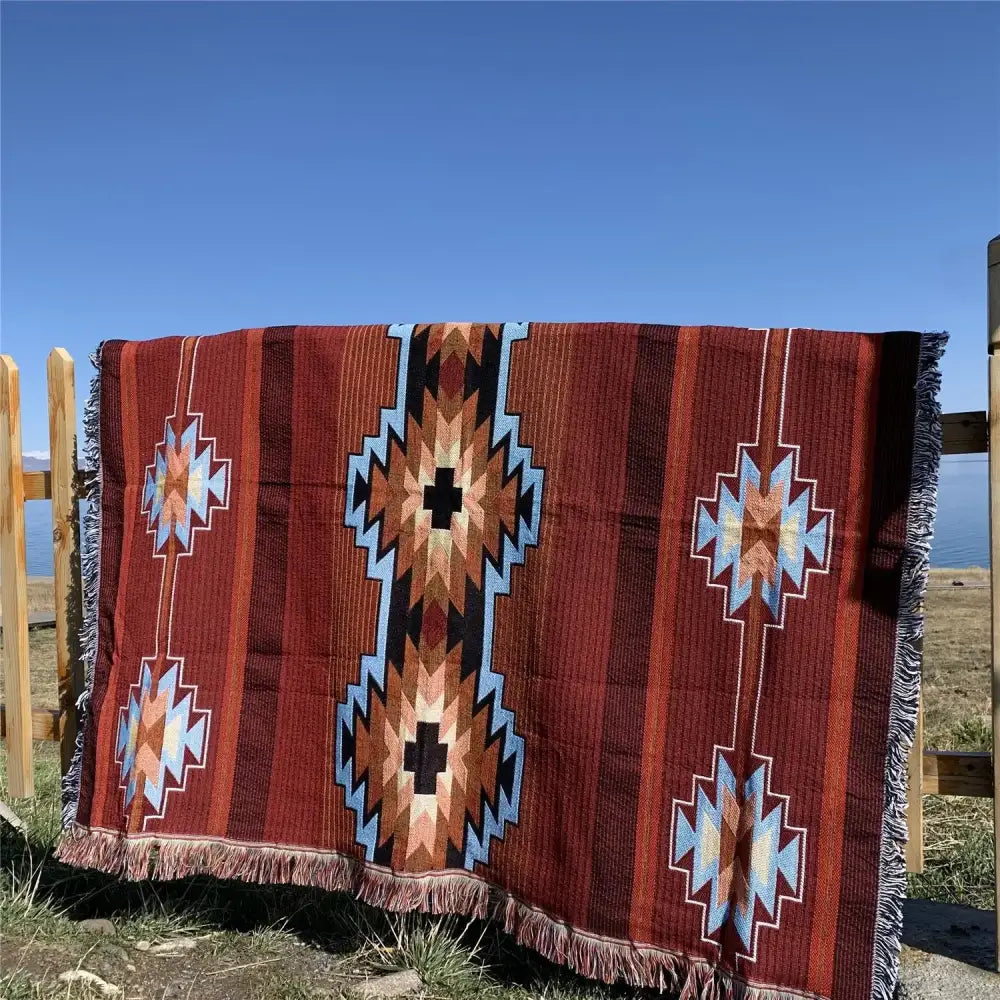 A richly patterned red bohemian knit throw blanket with blue black and beige geometric designs for living room decorbites decor