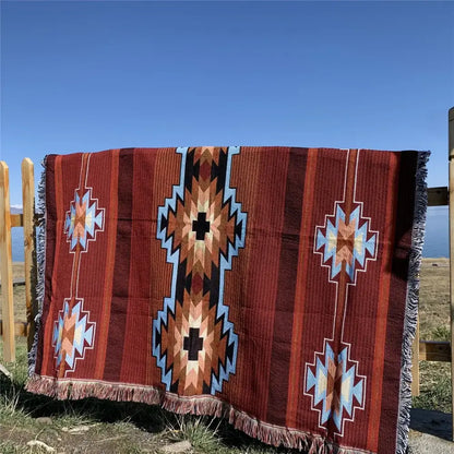 A richly patterned red bohemian knit throw blanket with blue black and beige geometric designs for living room decorbites decor