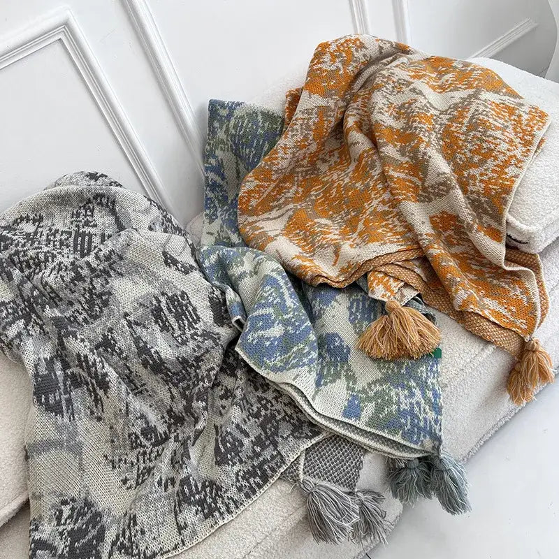 Three decorbites bohemian knitted blankets with earthy tones, tassels, and abstract patterns for bedroom throw decor