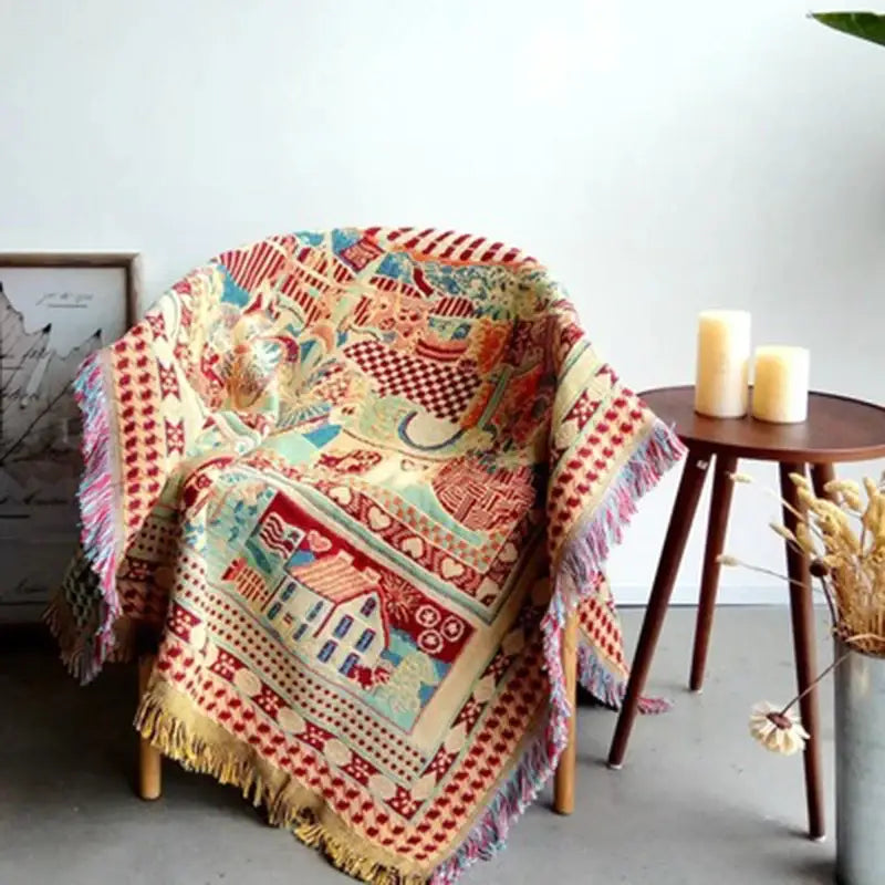 A cozy multicolored woven decorbites bohemian knitted sofa cover with patchwork design in earth tone colors