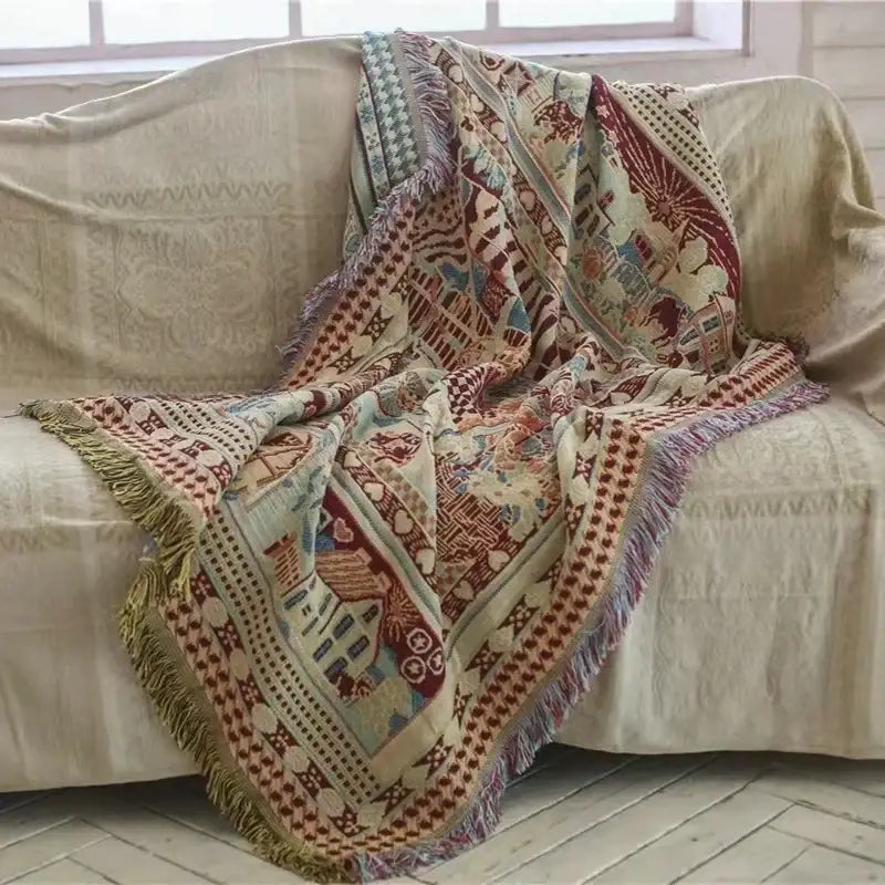 Cozy earth tone decorbites bohemian knitted sofa cover with multicolored geometric and floral patterns featuring fringed edges