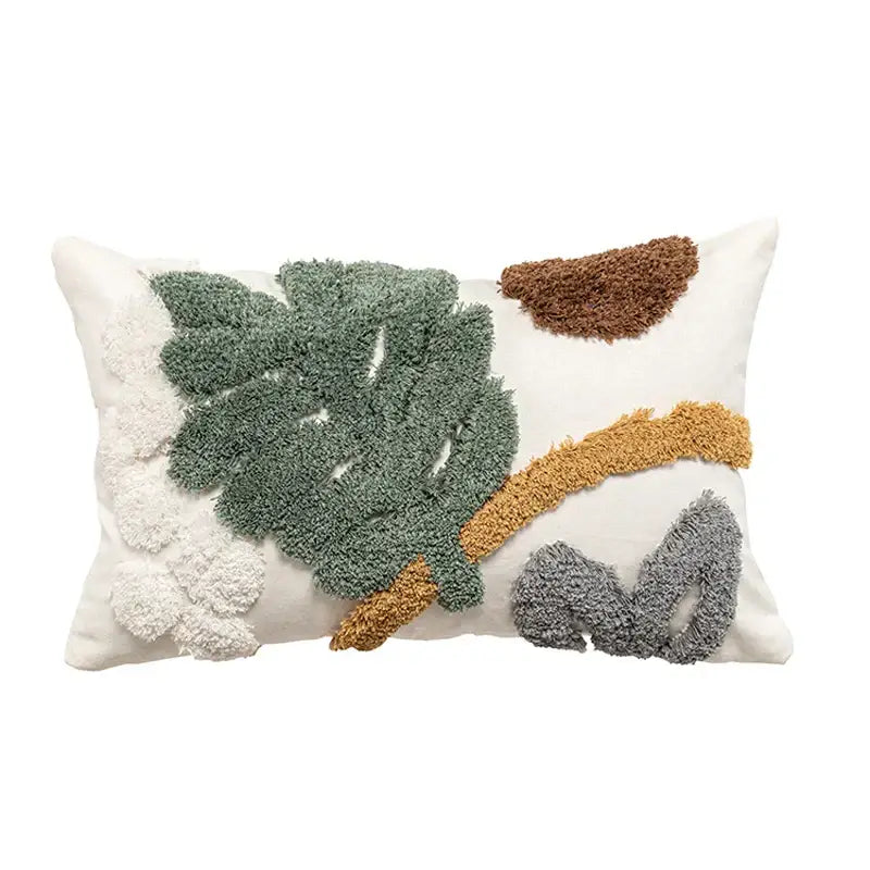 A bohemian loop white plush cushion cover featuring textured green brown gray and cream leaf appliqués for living room decor