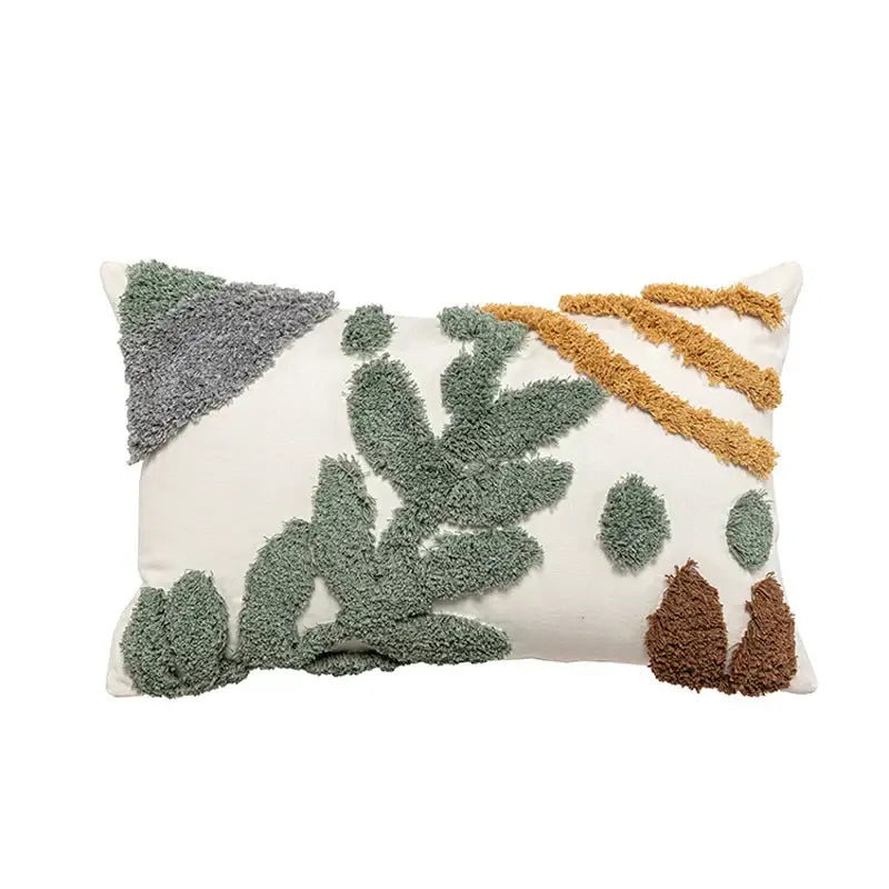 Cream-colored bohemian loop plush cushion cover with textured leaf appliqué in green, mustard, and brown for living room decor