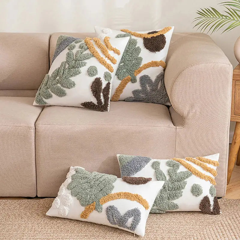 White plush cushion cover with textured tufted green brown and mustard yellow leaf patterns bohemian loop design