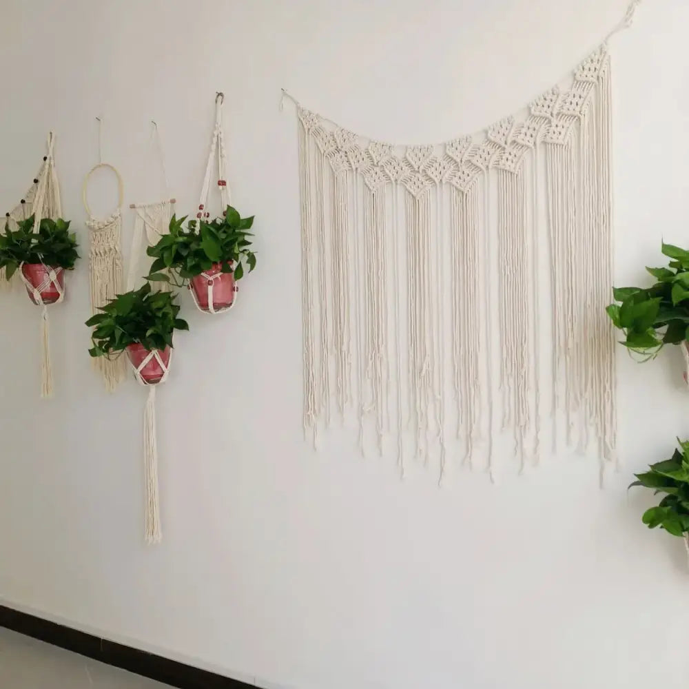 Cream-colored decorbites bohemian macrame curtain tapestry with intricate diamond pattern and long flowing fringe for living room decor