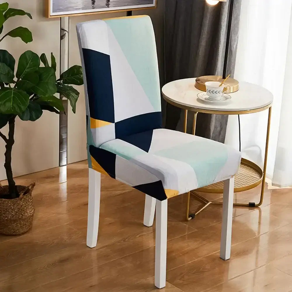 A bohemian mandala stretch chair cover in navy gold with geometric patterns, snugly fitted over a white dining chair