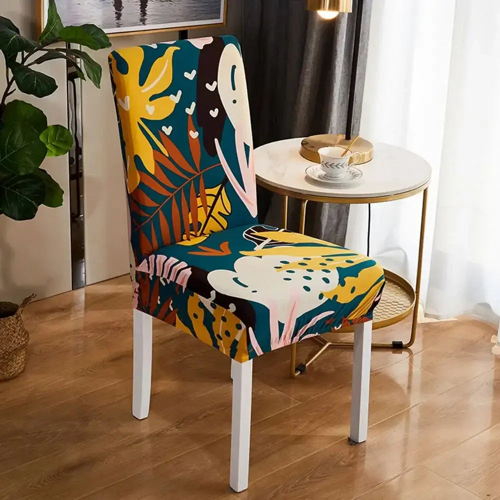 Vibrant tropical-themed bohemian mandala stretch chair cover in teal yellow and pink with leafy patterns for dining room decor