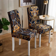 Elegant navy blue and gold paisley decorbites bohemian mandala stretch chair covers fit snugly over white modern chairs
