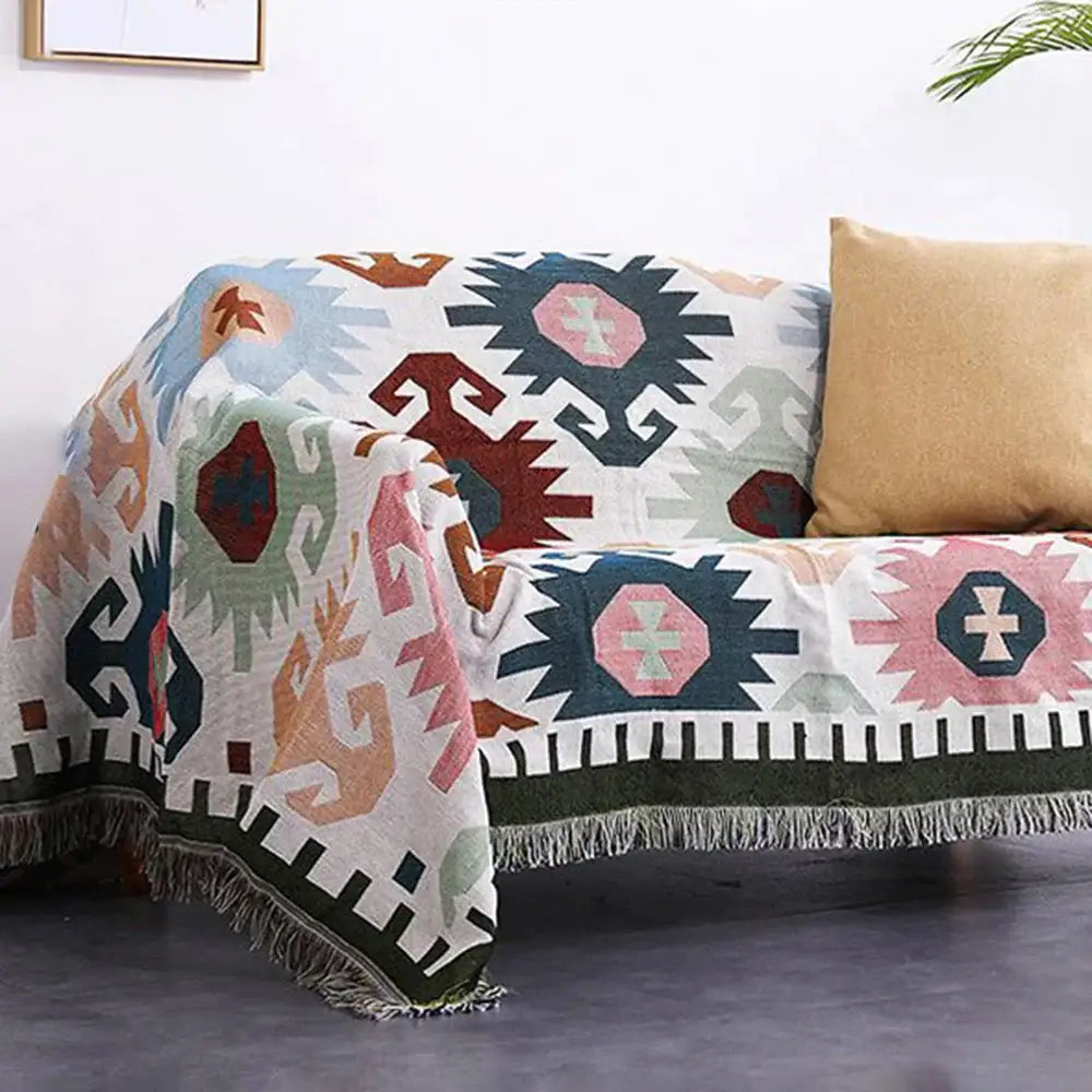 Cozy bohemian multicolored geometric tassel sofa cover with fringed edges and soft cotton texture for living room decorbites</assistant