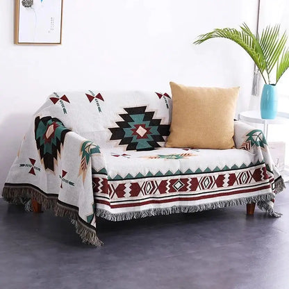 White woven bohemian multicolored geometric tassel sofa cover with black teal maroon patterns and fringed edges by decorbites