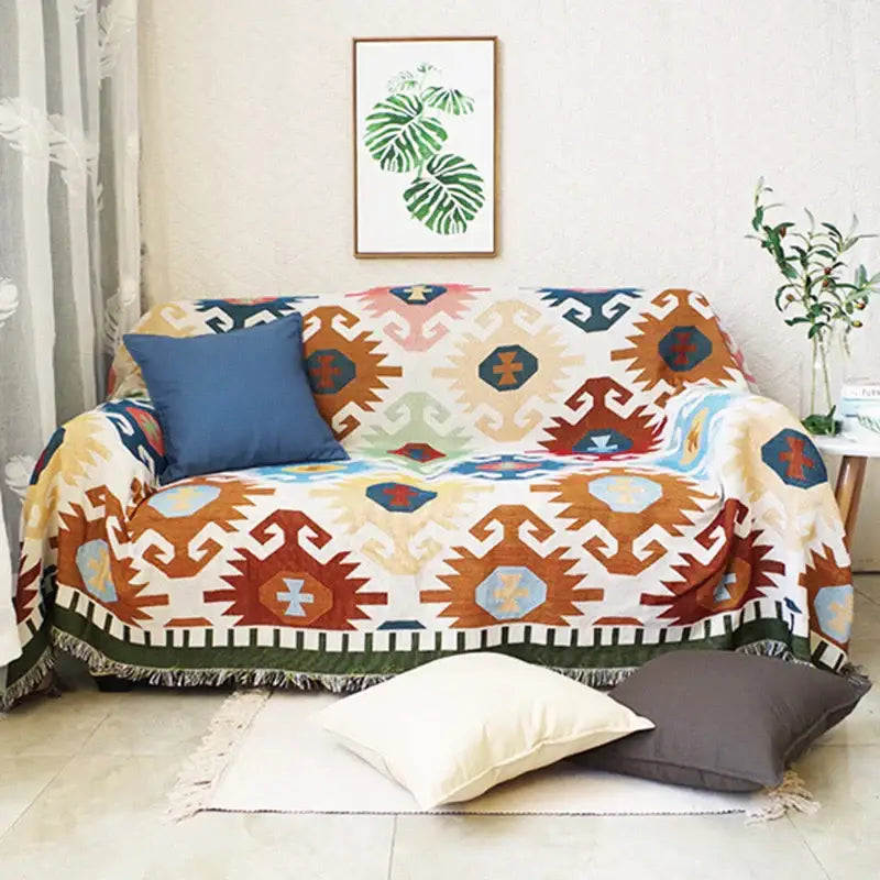 Bohemian multicolored geometric tassel sofa cover in warm earth tones with tribal-inspired decorbites geometric tassel design
